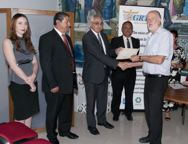 Mr Alexander Demarco, Deputy Governor, Central Bank of Malta presenting a certificate of attendance to one of the participants. Ms Abigail Mamo, CEO GRTU, Mr Paul Abela, President GRTU and Mr Paul R Muscat, Director Financial Services, Central Bank of Malta were also present. 